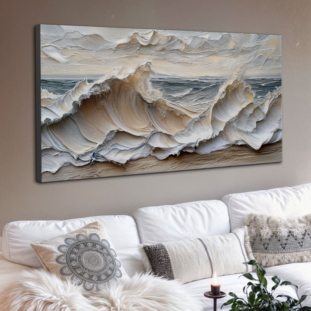 Wall art of ocean waves above a white sofa with decorative pillows.