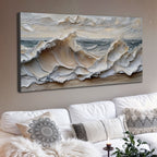 Wall art of ocean waves above a white sofa with decorative pillows.