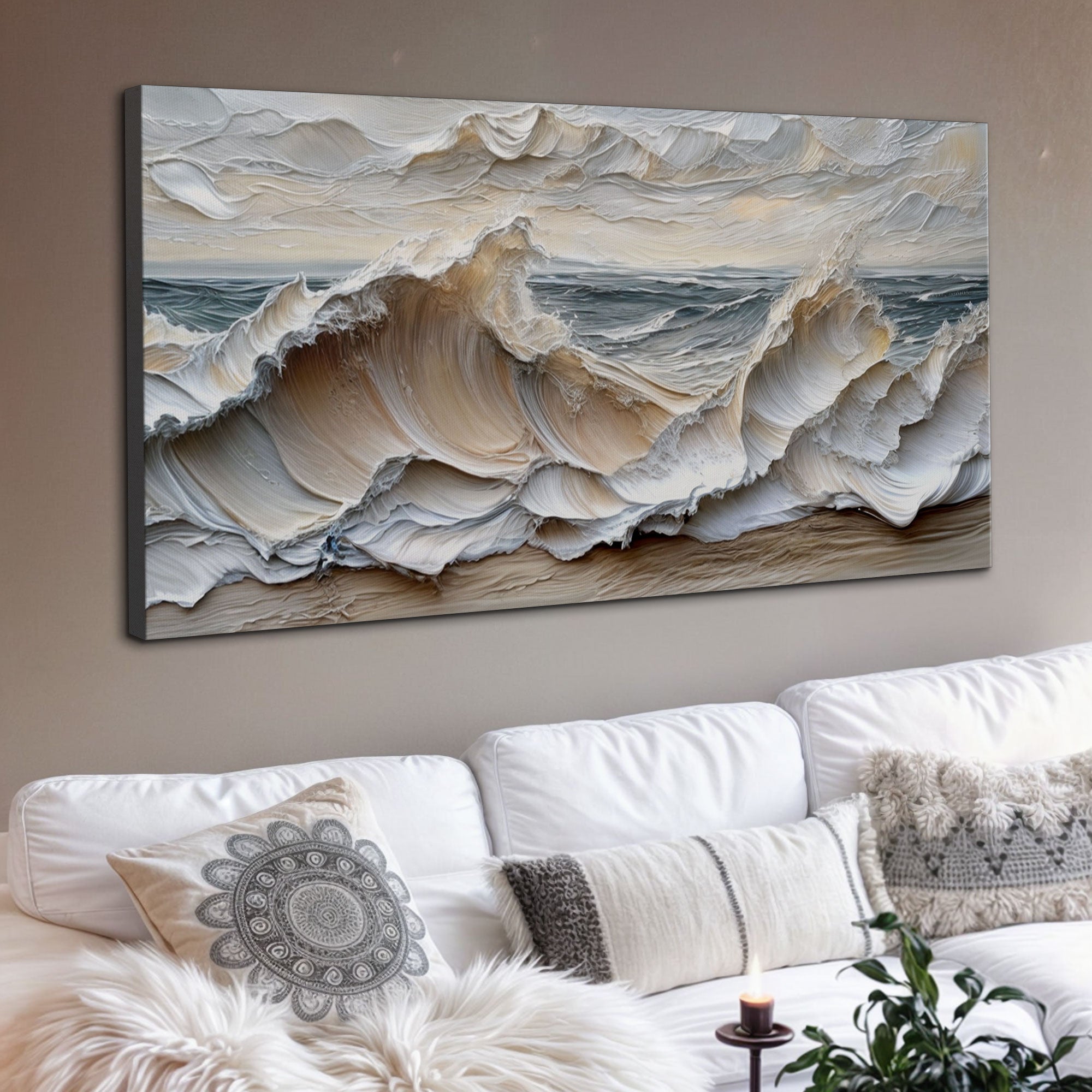 Wall art of ocean waves above a white sofa with decorative pillows.