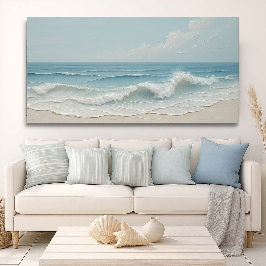 Beach-themed wall art above a white sofa with matching cushions in a living room setting.