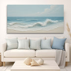 Beach-themed wall art above a white sofa with matching cushions in a living room setting.
