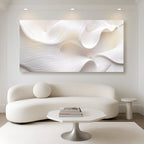 Modern living room with a white abstract painting on the wall, white sofa, and minimal decor.
