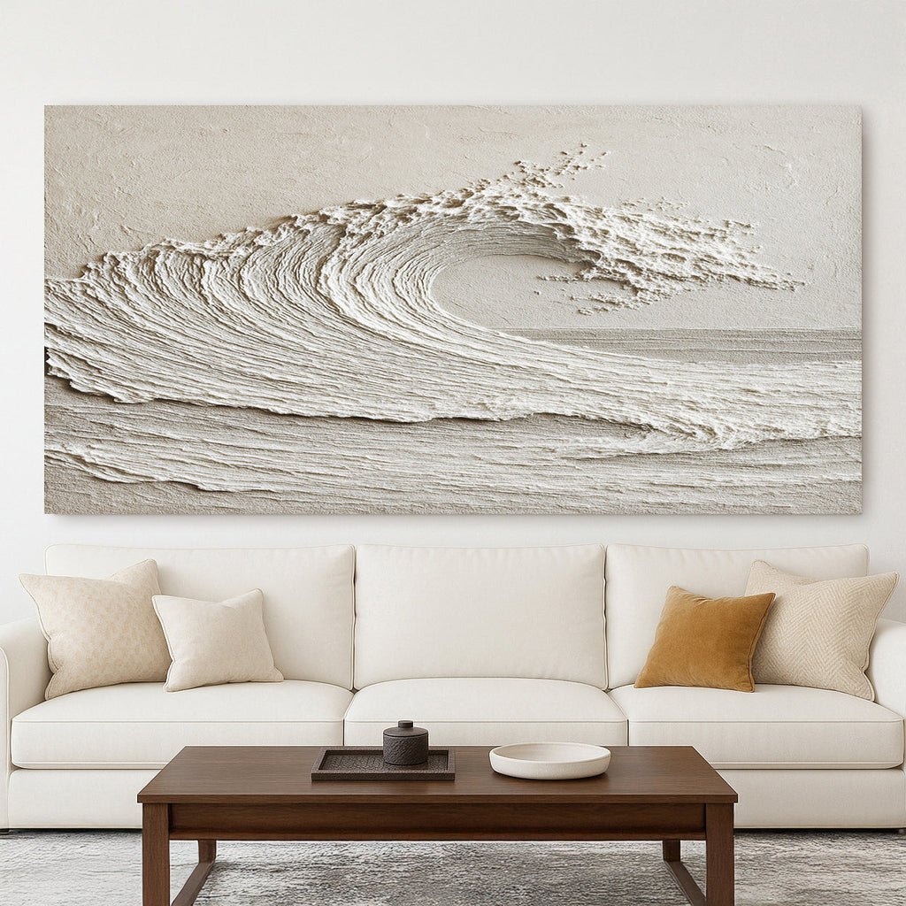 Abstract wall art of a wave above a white sofa with decorative pillows.