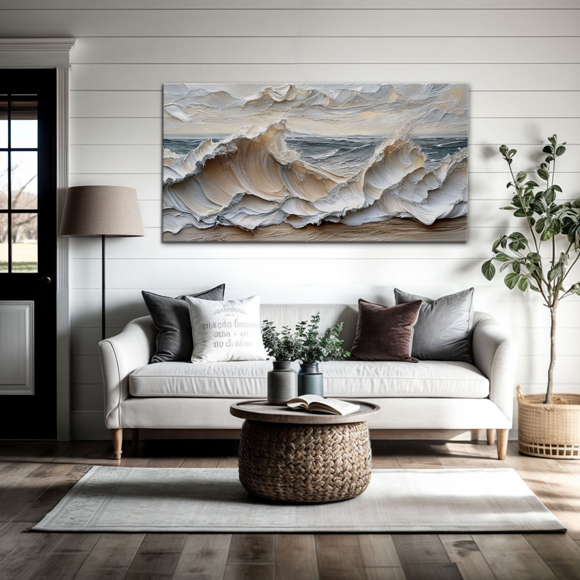 Living room with a large abstract painting of waves on the wall, a white sofa with pillows, and a coffee table.