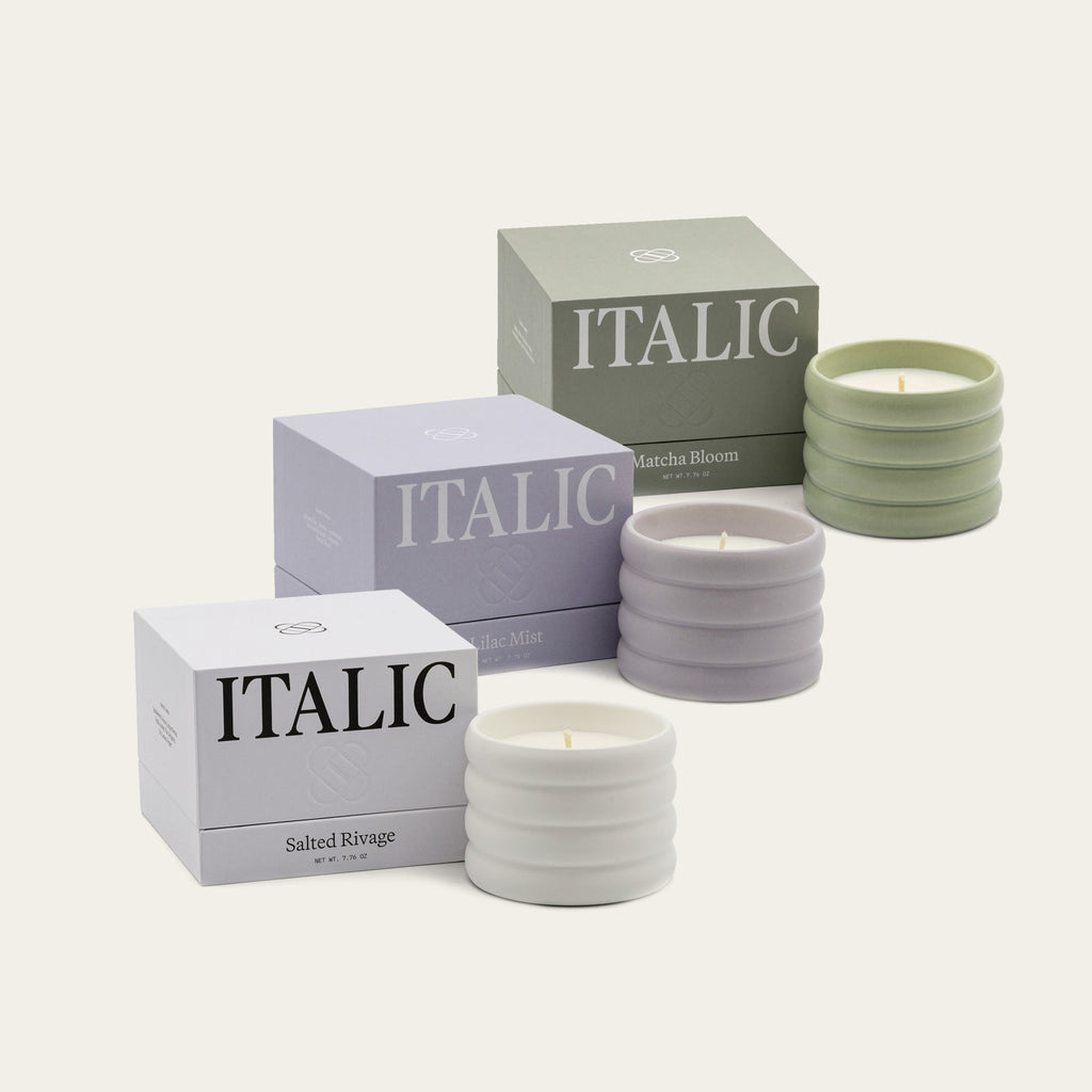 Set of candles with 'Italic' branding on boxes and containers.