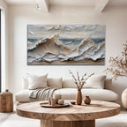 Living room with a large abstract painting of waves on the wall, a beige sofa, and a wooden coffee table.