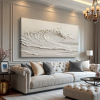 Living room with a large abstract wave wall art, a white sofa with pillows, and a chandelier.