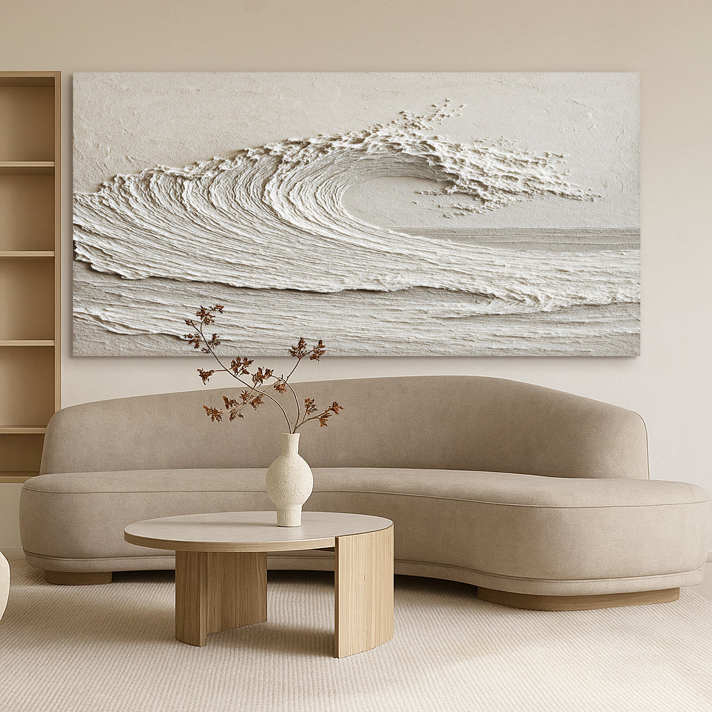 Beige sofa with a wooden coffee table and wall art of wave in a living room setting.
