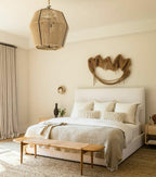 Cozy bedroom with a bed, bench, and decorative pillows