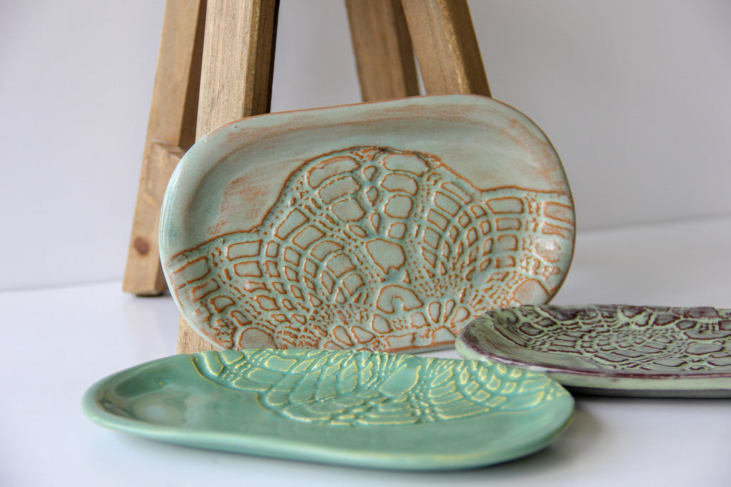 Two ceramic dishes with textured patterns on a white surface.