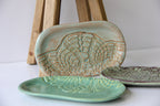 Two ceramic dishes with textured patterns on a white surface.