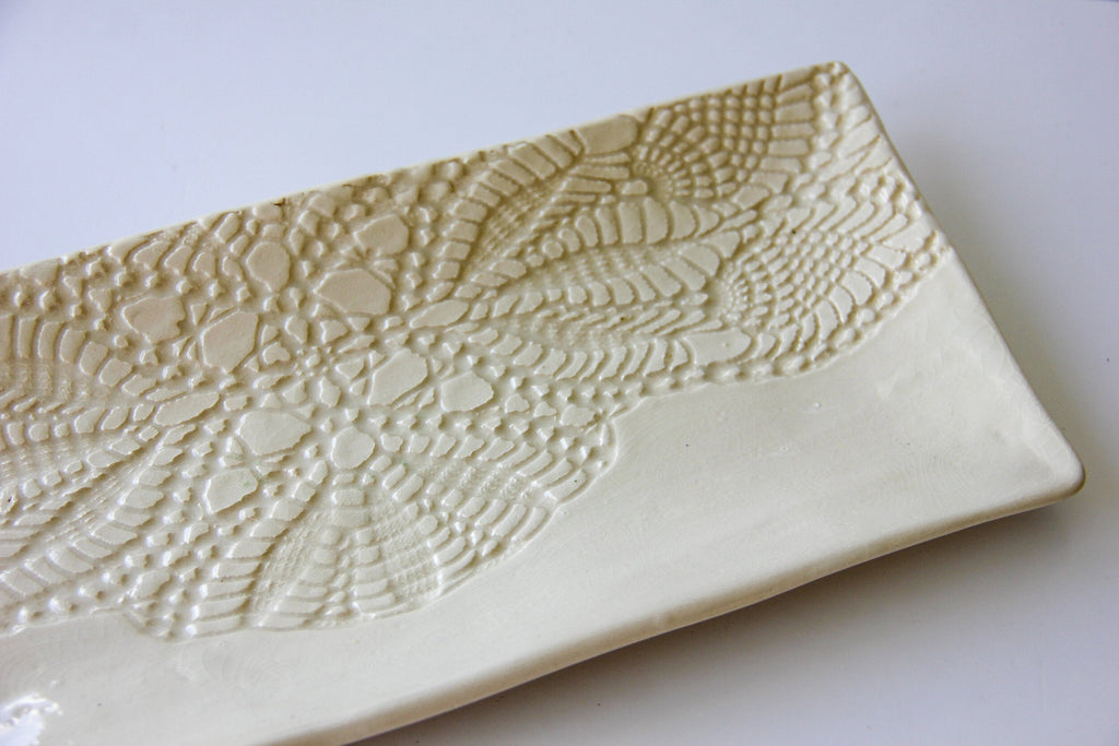 Rectangular ceramic platter with textured surface on a white background