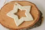 Star-shaped ceramic ornament on a wooden surface