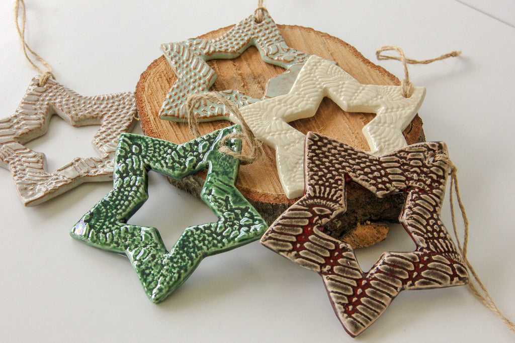 Decorative ceramic stars with textured surfaces on a white background