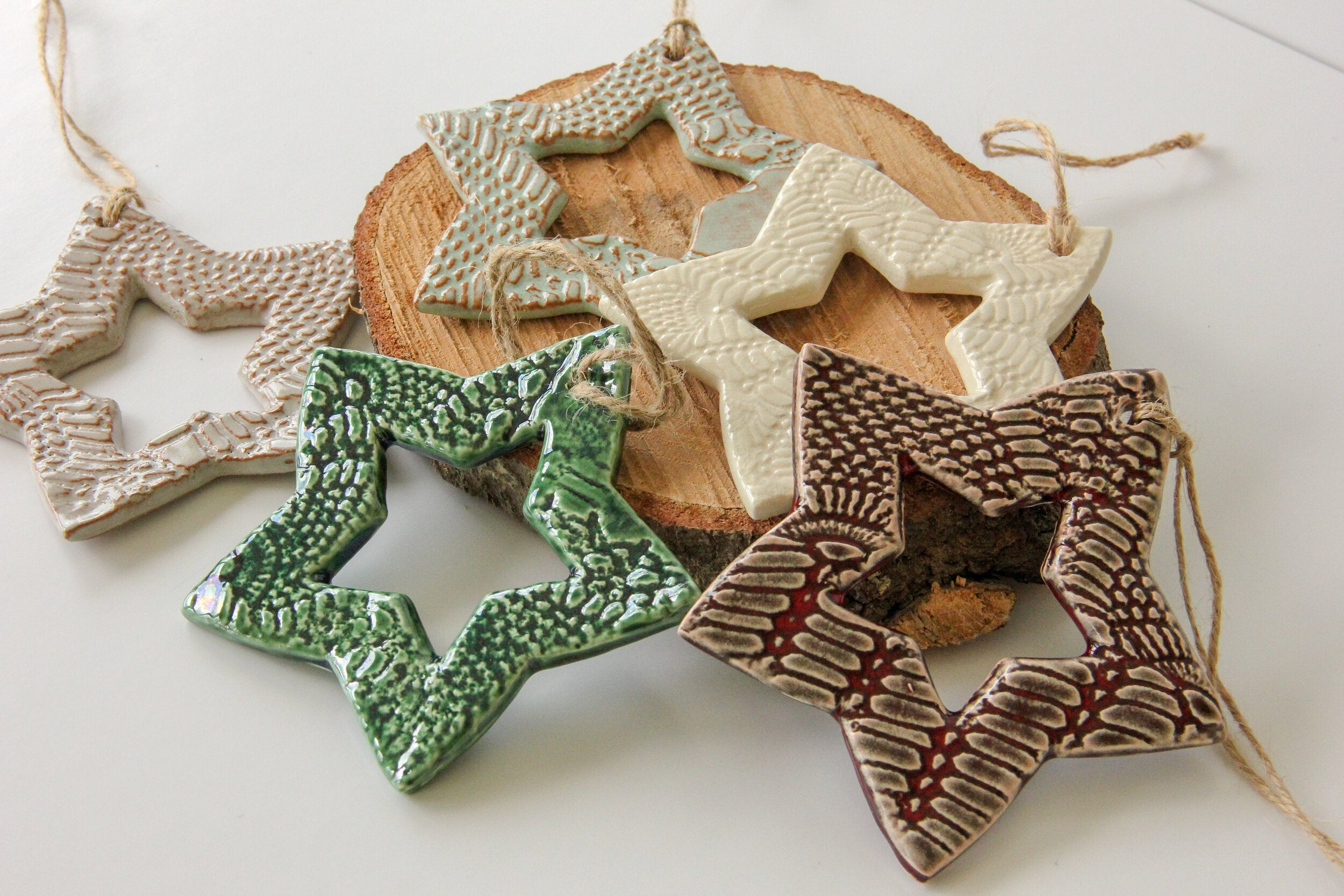 Decorative ceramic stars with textured surfaces on a white background