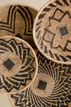 Woven baskets with geometric patterns on a beige background