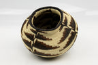 Woven basket with geometric pattern on a white background