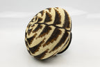 Woven basket with black and beige pattern on a white background