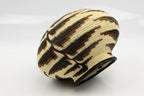 Woven basket with geometric pattern on a white background