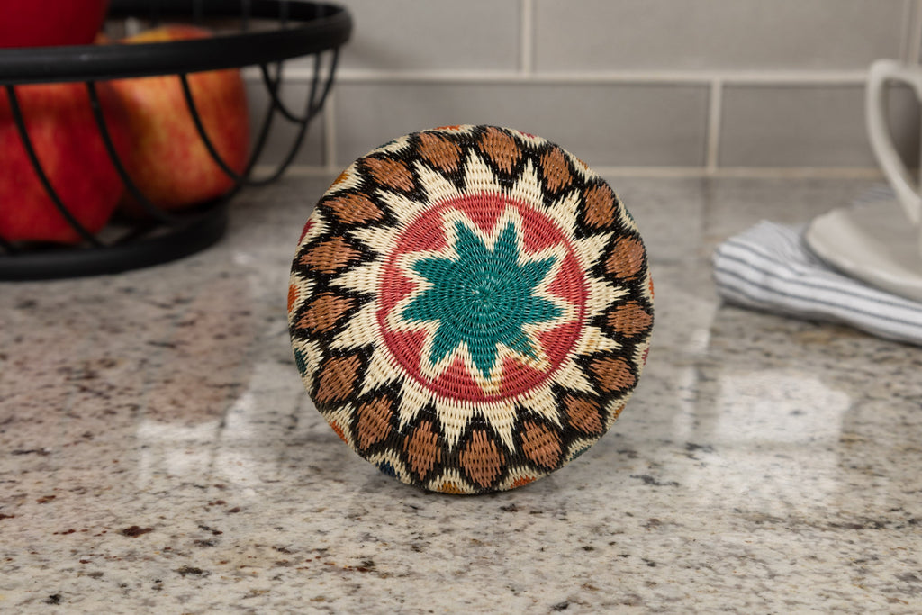 Decorative woven basket bottom with geometric pattern on a kitchen counter