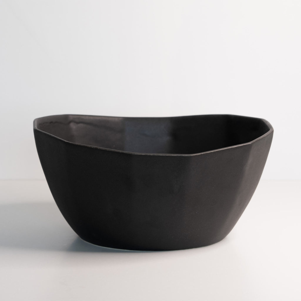 Black ceramic bowl on a light gray background