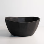 Black ceramic bowl on a light gray background
