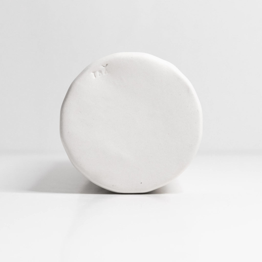 bottom of white oil dispenser bottle on white background