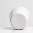 White ceramic cup bottom on a light gray background