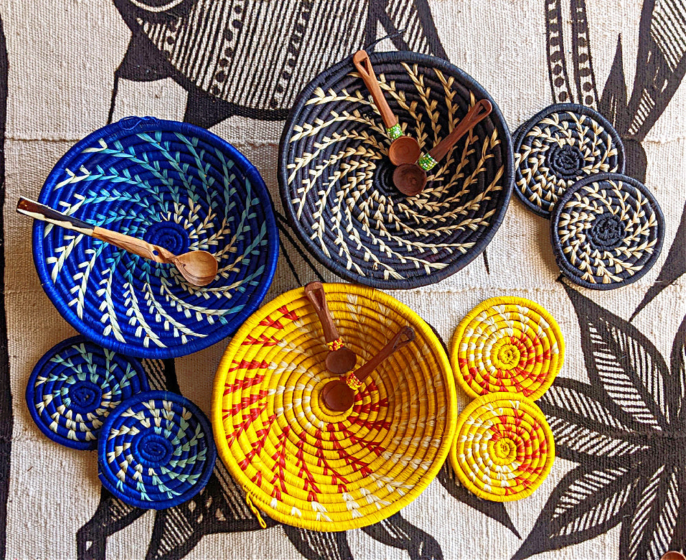 Woven baskets with wooden spoons on a patterned fabric background