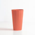 Terracotta-colored cup on a white background