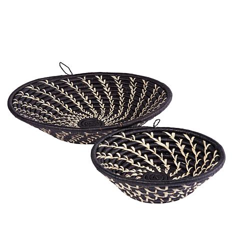 Two black woven baskets with beige patterns on a white background