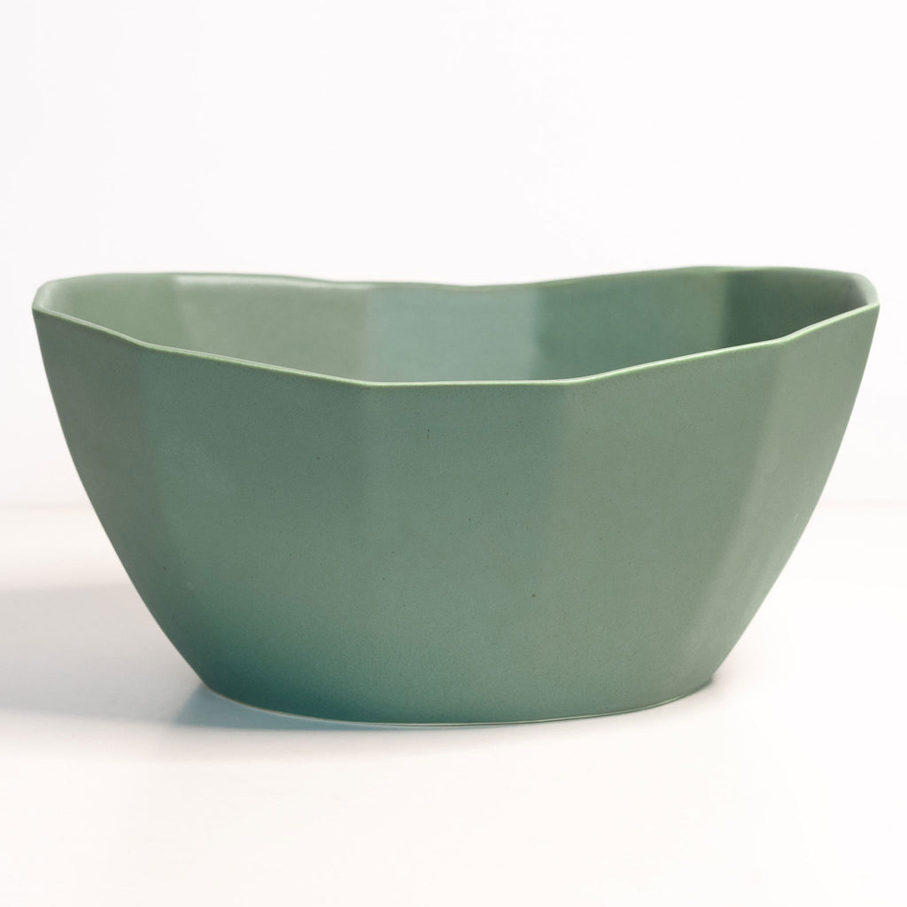 Green ceramic bowl on a white background