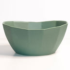 Green ceramic bowl on a white background