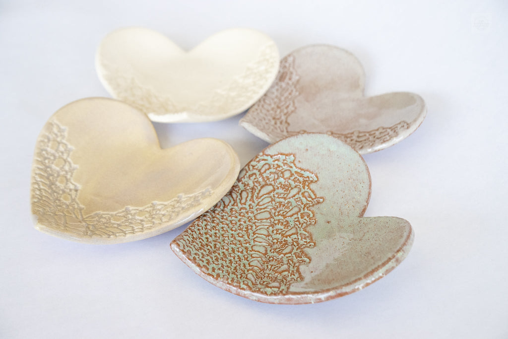 Heart-shaped ceramic dishes with textured surfaces on a white background