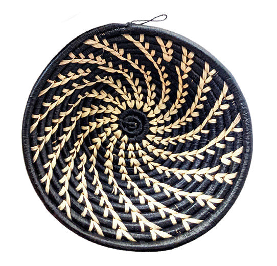 Round woven coaster with black and beige pattern on a white background
