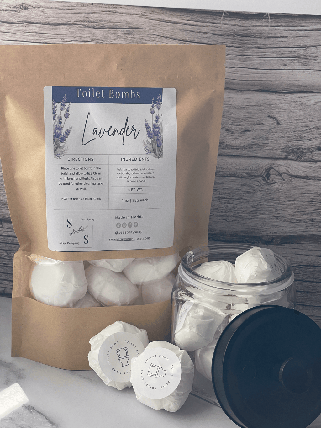 Lavender toilet bombs with packaging on a wooden surface